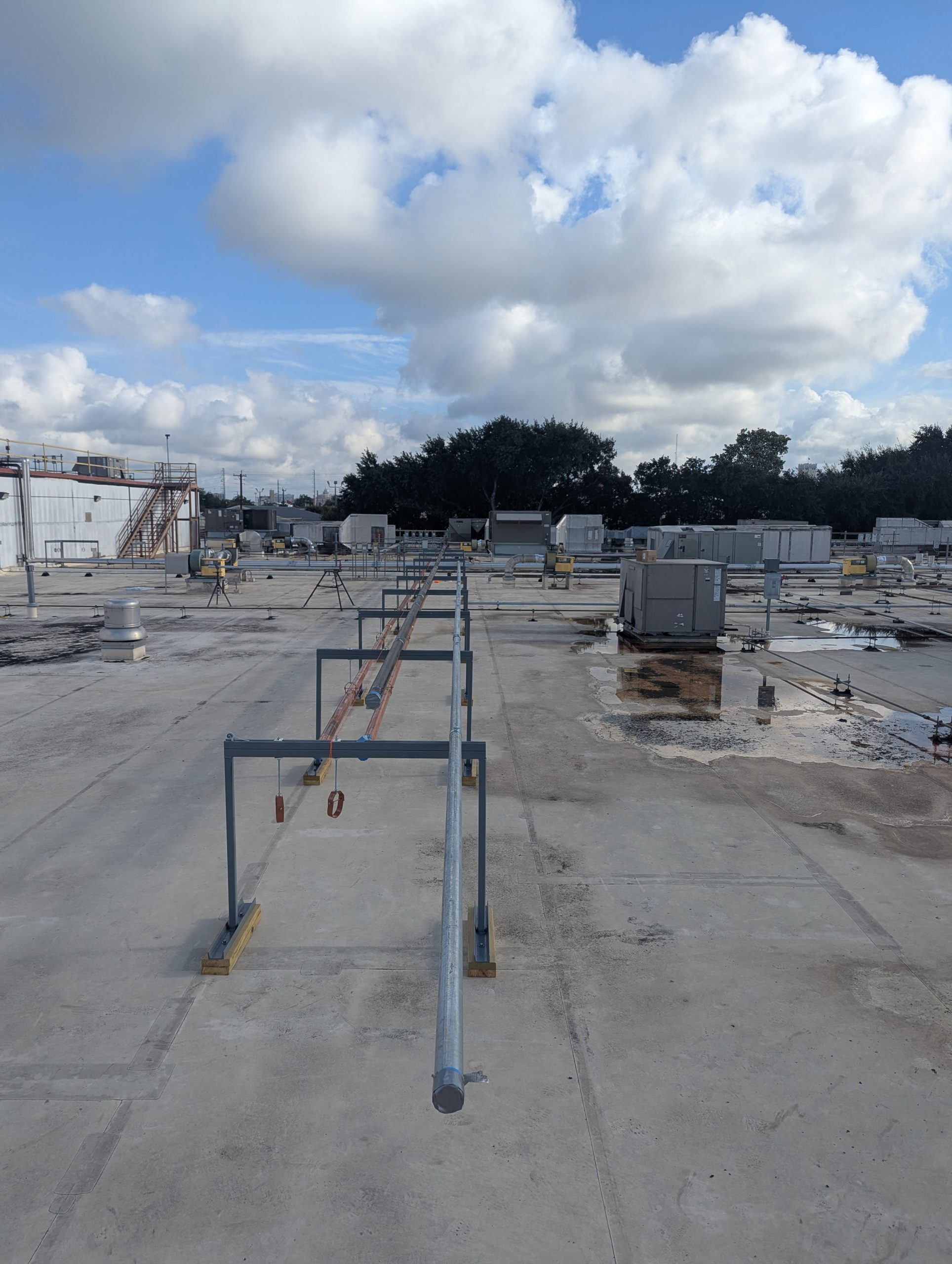 Industrial water piping installed across a commercial building roof